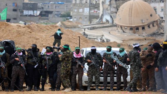 Palestinian Hamas fighters gather at the site of the handing over of the bodies of four Israeli hostages in Khan Yunis in the southern Gaza Strip on February 20, 2025. Hamas handed over the bodies of four hostages on February 20, including those of the Bibas family, who have become symbols of the hostage crisis that has gripped Israel since the Gaza war broke out. The transfer of the bodies is the first such handover of remains by Hamas since its October 7, 2023 attack on Israel triggered the war. (Photo by Omar AL-QATTAA / AFP)