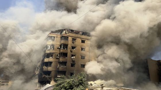 Smoke rises as a building collapses in Beirut's southern suburbs, Saturday, Sept. 28, 2024. (AP Photo/Hussein Malla)