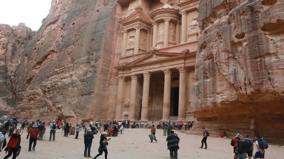 Tourists gather in front of the ancient Khaznah (treasury) monument carved in the rock cliff in Jordan's archaeological city of Petra, south of the capital Amman, on November 21, 2019. - Chosen in 2007 among the seven "New Wonders of the World", the ancient capital of the Nabateans carved in rock, whose fame spread as of the 1st century BC, is marking the arrival of over one million visitors in 2019. (Photo by AHMAD ABDO / AFP) (Photo by AHMAD ABDO/AFP via Getty Images)