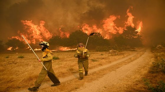TOPSHOT - Residents try to battle a wildfire in the village of Santa Baia de Montes in the province of Ourense, northwestern Spain on August 14, 2025. Southern Europe continued to endure its hellish summer on Thursday, suffering from a heatwave that has now lasted almost two weeks and forest fires that have left a third person dead in Spain. (Photo by MIGUEL RIOPA / AFP) (Photo by MIGUEL RIOPA/AFP via Getty Images)