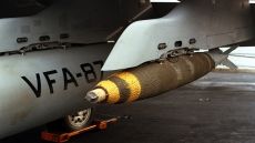 A Mark 82 500-pound general-purpose bomb hangs from a pylon beneath the wing of a Strike Fighter Squadron 87 (VFA-87) F/A-18A Hornet aircraft aboard the nuclear-powered aircraft carrier USS THEODORE ROOSEVELT (CVN-71) during Operation Desert Storm.