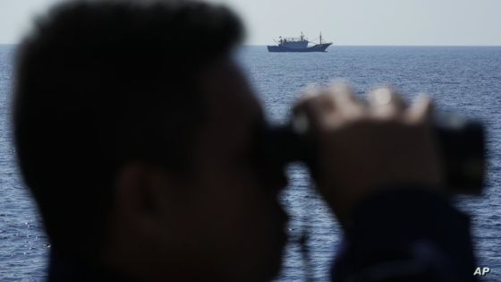 A suspected Chinese militia ship passes as members onboard the Philippine Coast Guard BRP Malabrigo drives them away from Philippine-occupied areas in the South China Sea on Friday, April 21, 2023. (AP Photo/Aaron Favila)