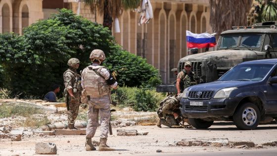 Members of the Russian military police are seen at the Nassib border crossing with Jordan in the southern province of Daraa on July 7, 2018, after the vital crossing was retaken by Syrian government forces the day before. - Soldiers burned a rebel flag as, together with Russian military police, they took over the crucial Nassib post on the border with Jordan on July 7, more than three years after it was conquered by rebels. (Photo by Youssef KARWASHAN / AFP) (Photo credit should read YOUSSEF KARWASHAN/AFP/Getty Images)