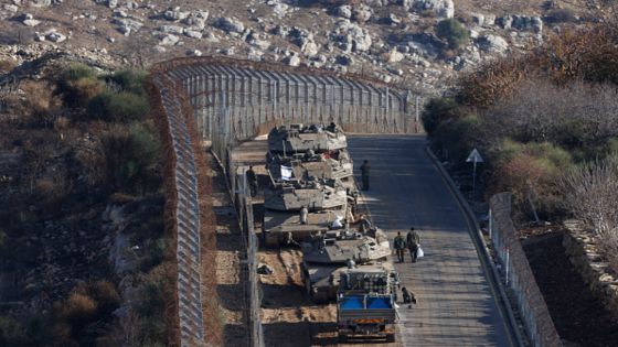Israeli tanks take position near the fence with the buffer zone that separates the Israeli-annexed Golan Heights from the rest of Syria near the Druze village of Majdal Shams on December 8, 2024. The Israeli military said on December 8, it had deployed forces to a demilitarised buffer zone in southwest Syria abutting the Israel-annexed Golan after Damascus fell to rebel forces. (Photo by Jalaa MAREY / AFP) (Photo by JALAA MAREY/AFP via Getty Images)