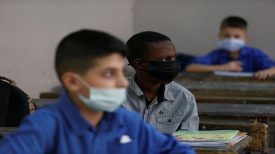 Students wearing protective face masks attend a class at one of the public schools on the first day of the new school year, amid fears of rising number of the coronavirus disease (COVID-19) cases in Amman, Jordan September 1, 2020. REUTERS/Muhammad Hamed