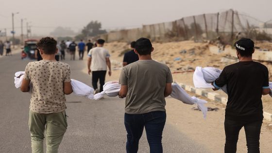 EDITORS NOTE: Graphic content / Members of the al-Zanati, family killed following an Israeli strike, are taken to a waiting vehicle to be driven to a cemetery for burial in Khan Yunis on October 23, 2023, as battles continue between Israel and the Palestinian Hamas group. - Thousands of people, both Israeli and Palestinians have died since October 7, 2023, after Palestinian Hamas militants based in the Gaza Strip, entered southern Israel in a surprise attack leading Israel to declare war on Hamas in Gaza on October 8. (Photo by MAHMUD HAMS / AFP)