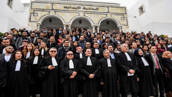 Tunisian judges stand in a vigil attended by the chief of the Tunisian Bar Association Ameur Mehrezi (4th-R) outside Ben Arous Preliminary court in the locality of the same name near the Tunisian capital Tunis on March 1, 2018, as a two-hour strike was observed throughout the country's courts. / AFP PHOTO / FETHI BELAID (Photo credit should read FETHI BELAID/AFP via Getty Images)