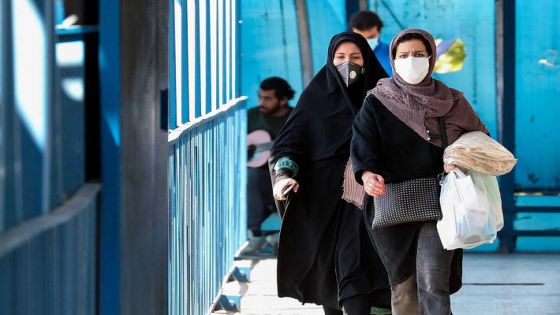Women wearing protective masks amid the coronavirus pandemic walk by in Iran's capital Tehran, on April 5, 2021. - Iran's daily new COVID-19 infections reached a four-month high, said the health ministry, as the capital Tehran was put on the highest virus risk level. (Photo by ATTA KENARE / AFP)