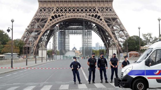 French police stand near the Eiffel Tower after the French tourism landmark was evacuated following a bomb alert in Paris, France, September 23, 2020. REUTERS/Charles Platiau