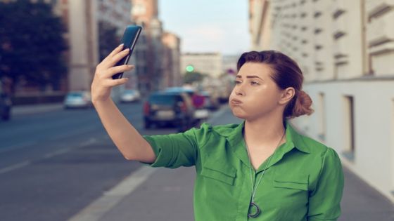 lifestyle shot of sad and displeased woman in the city trying to find signal for her smart phone.