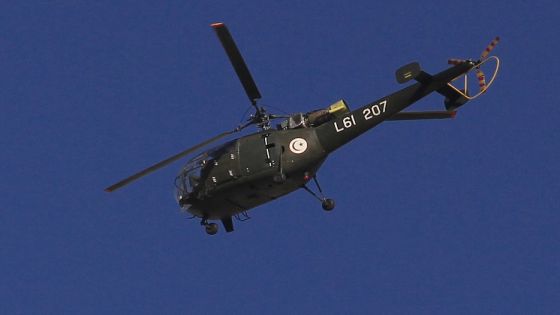 A Tunisian army helicopter flies over the capital Tunis January 15, 2011. Hundreds of soldiers patrolled the streets of the Tunisian capital on Saturday where the prime minister was due to meet opposition parties to try to form a coalition after protests swept the president from power. REUTERS/Zohra Bensemra (TUNISIA- Tags: POLITICS CIVIL UNREST TRANSPORT MILITARY)