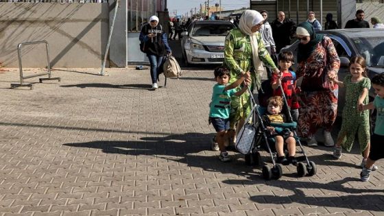 People enter the Rafah border crossing in the southern Gaza Strip before crossing into Egypt on November 1, 2023. Scores of foreign passport holders trapped in Gaza started leaving the war-torn Palestinian territory on November 1 when the Rafah crossing to Egypt was opened up for the first time since the October 7 Hamas attacks on Israel, according to AFP correspondents. (Photo by Mohammed ABED / AFP)