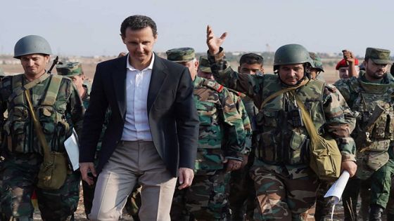 A handout picture released by the official Facebook page for the Syrian Presidency on October 22, 2019, shows Syrian President Bashar al-Assad listening to army soldiers in al-Habit on the southern edges of the Idlib province. - Syrian President Bashar al-Assad visited government troops on the front line with jihadists in Idlib, his first visit to the northwestern province since the start of the conflict. (Photo by - / Syrian Presidency Facebook page / AFP) / RESTRICTED TO EDITORIAL USE - MANDATORY CREDIT "AFP PHOTO / Syrian Presidency Facebook page " - NO MARKETING NO ADVERTISING CAMPAIGNS - DISTRIBUTED AS A SERVICE TO CLIENTS
