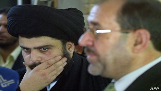 Radical Shiite cleric Moqtada al-Sadr (L) gestures during a joint press conference with Iraqi prime minister designate Nuri al-Maliki (R) in the holy city of Najaf, 160 kms south of Baghdad, 27 April 2006. Sadr criticised the "flagrant" interference in Iraq's internal affairs by the United States, in reference to the latest visit to the war-torn country by US Secretary of State Condoleezza Rice and Defense Secretary Donald Rumsfeld. AFP PHOTO/QASSEM ZEIN (Photo by QASSEM ZEIN / AFP)