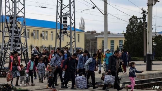 Families walk on a platform on their way to board a train at Sloviansk central station, in the Donbass region on April 12, 2022, amid Russian invasion of Ukraine. (Photo by RONALDO SCHEMIDT / AFP)