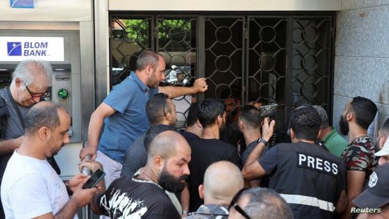 People stand outside a Blom Bank branch in the Tariq al-Jdideh neighborhood in Beirut, Lebanon September 16, 2022. REUTERS/Mohamed Azakir