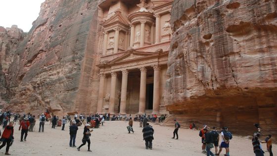 Tourists gather in front of the ancient Khaznah (treasury) monument carved in the rock cliff in Jordan's archaeological city of Petra, south of the capital Amman, on November 21, 2019. - Chosen in 2007 among the seven "New Wonders of the World", the ancient capital of the Nabateans carved in rock, whose fame spread as of the 1st century BC, is marking the arrival of over one million visitors in 2019. (Photo by AHMAD ABDO / AFP) (Photo by AHMAD ABDO/AFP via Getty Images)