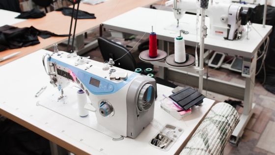 Interior of garment factory shop. Closes making atelier with several sewing machines. Tailoring industry, fashion designer workshop, industry concept