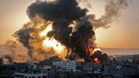 A fire rages at sunrise in Khan Yunish following an Israeli airstrike on targets in the southern Gaza strip, early on May 12, 2021. - Israeli air raids in the Gaza Strip have hit the homes of high-ranking members of the Hamas militant group, the military said Wednesday, with the territory's police headquarters also targeted. (Photo by YOUSSEF MASSOUD / AFP) (Photo by YOUSSEF MASSOUD/AFP via Getty Images)