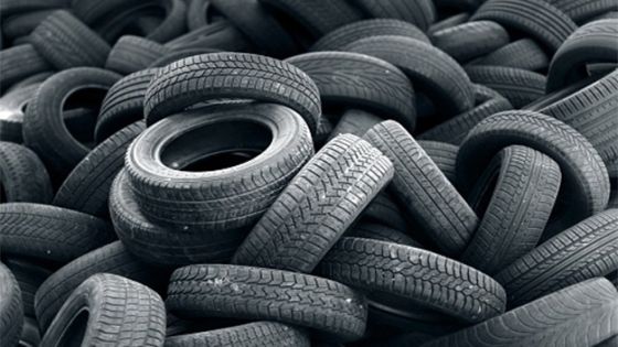 Old used car tires heap background