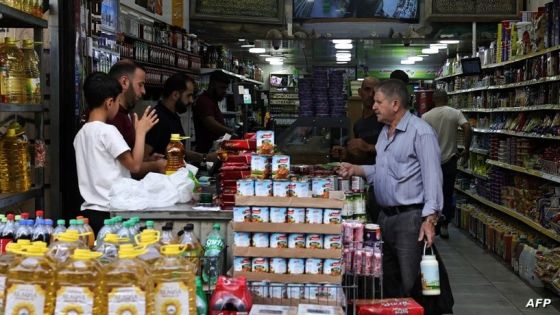 A Palestinian speaks to a shop keeper in a store located in the old city of Nablus, in the Israeli occupied West Bank on June 9, 2024. (Photo by Zain JAAFAR / AFP)