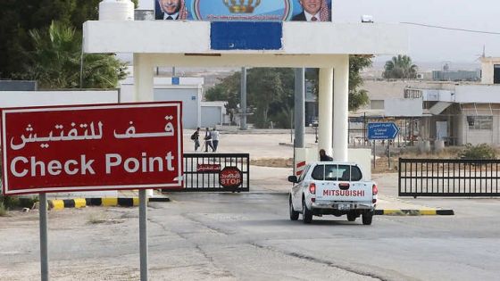 A vehicle arrives at the Jaber border crossing between Jordan and Syria (Nassib crossing on the Syrian side) on the day of its reopening on October 15, 2018 in the Jordanian Mafraq governorate. Portraits of Jordan's King Abdullah II (R) and his late father King Hussein. - The main border crossing between Jordan and war-torn Syria reopened on October 15 after a three year closure, an AFP photographer reported. The black metal border gate was opened from the Jordanian side of the crossing at 8:00 am (0500 GMT) as more than a dozen police and customs officials stood nearby, the photographer said, while several cars bearing Jordanian license plates queued on the Syrian side ready to roll in. (Photo by Khalil MAZRAAWI / AFP)