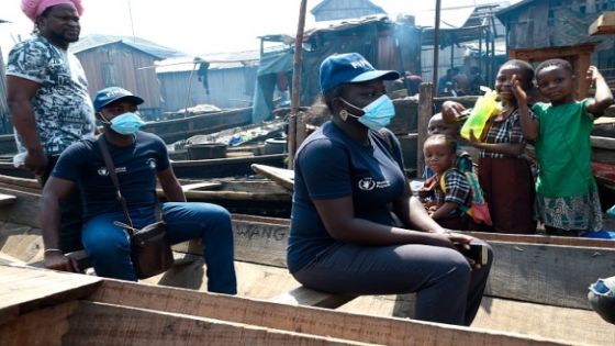 Field officers of Finpact Development Foundation (FINDEF) Kemi Ogunnowo (R) and Femi arrive in a boat to facilitate distribution of cash and food provided by World Food Programme (WFP) in a makeshift home in the Makoko riverine slum settlement in Lagos on November 27, 2020. - The United Nations World Food Programme (WFP) has round off cash and food assistance across the country to most vulnerable people to cushion the effect of Covid-19 pandemic in the cities of Abuja, Kano and Makoko slum settlement in Lagos, the epic center of the virus in Nigeria, Africa's biggest economy and most populous country. (Photo by PIUS UTOMI EKPEI / AFP) (Photo by PIUS UTOMI EKPEI/AFP via Getty Images)