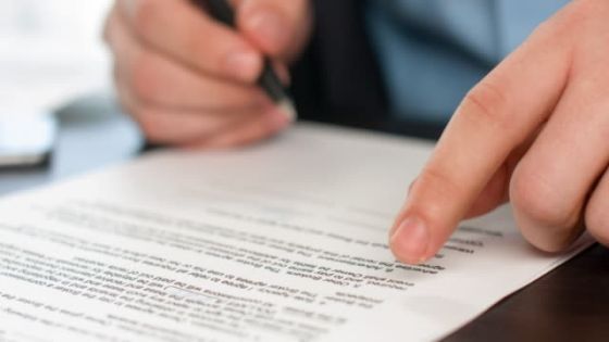 Close up of hand signing document