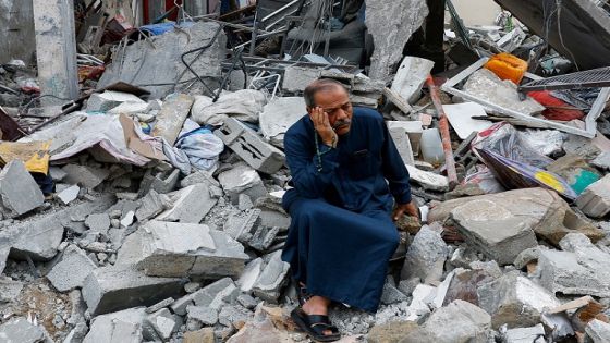 A Palestinian sits on the rubble of a building destroyed in Israeli strikes, in Rafah in the southern Gaza Strip October 9, 2023. REUTERS/Ibraheem Abu Mustafa TPX IMAGES OF THE DAY