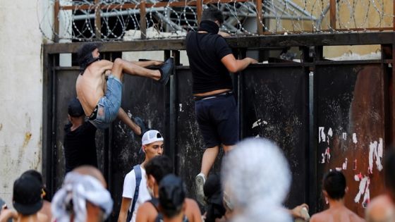 Demonstrators attempt to climb over a gate during a protest near parliament, as Lebanon marks the one-year anniversary of the explosion in Beirut, Lebanon August 4, 2021. REUTERS/Mohamed Azakir