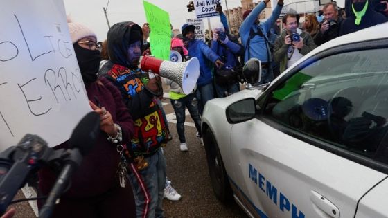 People protest next to a police car after the release of the body cam footage showing police officers beating Tyre Nichols, the young Black man who died three days after he was pulled over while driving during a traffic stop by Memphis police officers, in downtown Memphis, Tennessee, U.S., January 28, 2023. REUTERS/Leah Millis