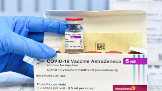 FILE PHOTO: A healthcare worker shows a vial and a box of the AstraZeneca coronavirus disease (COVID-19) vaccine, as vaccinations resume after a brief pause in their use over concern for possible connection to blood clots, in Turin, Italy, March 19, 2021. REUTERS/Massimo Pinca/File Photo