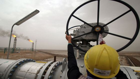 An employee turns a valve at the Hammar Mushrif new Degassing Station Facilities site inside the Zubair oil and gas field, north of the southern Iraqi province of Basra on May 9, 2018. (Photo by HAIDAR MOHAMMED ALI / AFP) (Photo credit should read HAIDAR MOHAMMED ALI/AFP via Getty Images)