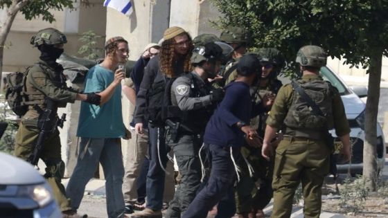 Israeli soldiers restrain Jewish settlers after they stormed the Palestinian West Bank village of Dayr Sharaf, located about seven kilometres (four miles) from the Jewish Einav settlement following the death of an Israeli man on November 2, 2023, amid the ongoing battles between Israel and the Palestinian group Hamas in the Gaza Strip. Three Palestinians were killed on November 2, 2023, by Israeli fire in the occupied West Bank, the Palestinian health ministry said, and an Israeli was killed in a Palestinian shooting attack, according to first responders. (Photo by Jaafar ASHTIYEH / AFP)