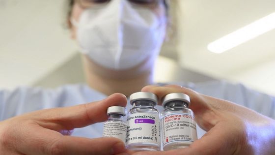A woman wearing a face mask shows three vials with different vaccines against Covid-19 by (L-R) Pfizer-BioNTech, AstraZeneca and Moderna in the pharmacy of the vaccination center at the Robert Bosch hospital in Stuttgart, southern Germany, on February 12, 2021, amid the novel coronavirus / COVID-19 pandemic. (Photo by THOMAS KIENZLE / AFP)