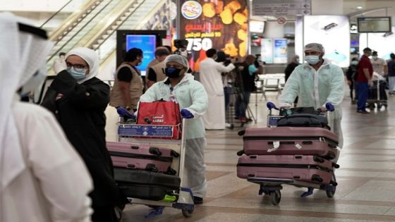 Repatriated Kuwaitis from Amman, wearing protective face masks and suits, are seen after arriving at the Kuwait Airport, following the outbreak of the coronavirus disease (COVID-19), in Kuwait City, Kuwait April 21, 2020. REUTERS/Stephanie McGehee
