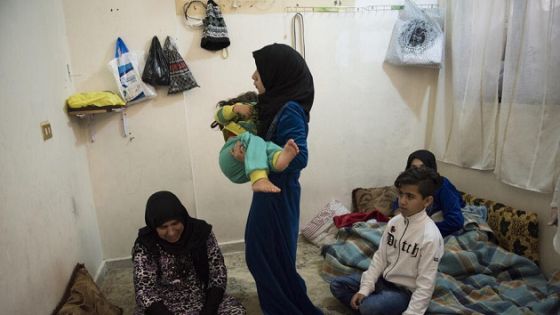 Syrian refugee Kutna sits with her family in the room where they live. Syrian refugee Kutna lives in an apartment block in Mount Lebanon, exchanging cleaning services for rent. She has four children, three of whom live with her - Mohammed (12), Hania (14) and Kholoud (4). Her eldest son lives with his wife Hiba, who has just given birth to a baby. The family comes from Aleppo. Kutna’s husband joined his family in Lebanon a few months ago.