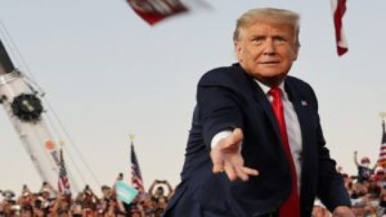 U.S. President Donald Trump tosses face masks to the crowd as he takes the stage for a campaign rally, his first since being treated for the coronavirus disease (COVID-19), at Orlando Sanford International Airport in Sanford, Florida, U.S., October 12, 2020. REUTERS/Jonathan Ernst