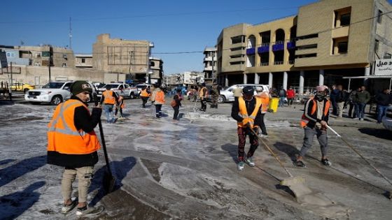 Workers clean the site of a twin suicide bombing attack in a central market in Baghdad, Iraq January 21, 2021. REUTERS/Thaier al-Sudani