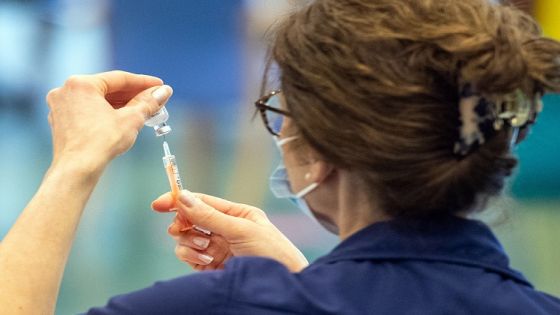 A nurse prepares a dose of the Oxford/AstraZeneca Covid-19 vaccine at a mass vaccination centre at Epsom Downs Racecourse in Epsom, southern England on January 11, 2021. - Seven mass coronavirus vaccination sites opened across England on Monday as the government races to dose millions of people while a new strain of the disease runs rampant across the country. The sites include football stadiums and a horse racing course, and are located in cities including Bristol, London, Newcastle and Manchester. (Photo by Dominic Lipinski / POOL / AFP) (Photo by DOMINIC LIPINSKI/POOL/AFP via Getty Images)