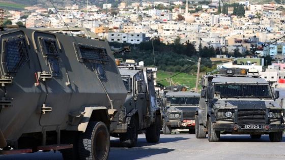 epa11048158 Israeli army vehicles during an Israeli army raid in Al-Far'a refugee camp, near the West Bank city of Tubas, 29 December 2023. At least seven Palestinians were wounded during an Israeli military raid on the refugee camp, the Palestinian Health Ministry said. EPA/ALAA BADARNEH