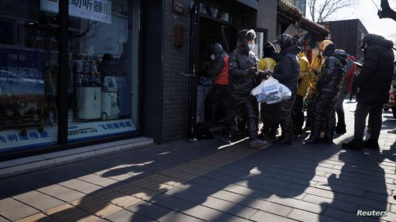 A delivery driver picks up medicine from a pharmacy as coronavirus disease (COVID-19) outbreaks continue in Beijing, December 7, 2022. REUTERS/Thomas Peter