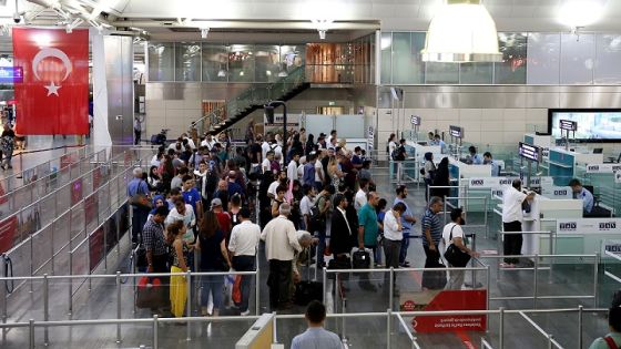 ISTANBUL, TURKEY - JULY 17: People wait as Turkish police officers tighten security control to prevent Parallel State/Gulenist Terrorist Organization's failed military coup attempt's supporters escaping at Ataturk and Sabiha Gokcen International Airport in Istanbul, Turkey on July 17, 2016. Parallel state is an illegal organization backed by U.S.-based preacher Fetullah Gulen. (Photo by Berk Ozkan/Anadolu Agency/Getty Images)