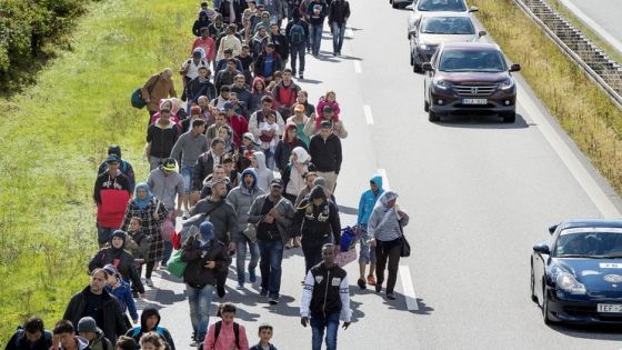 A large group of migrants, mainly from Syria, walk on a highway towards the north September 7, 2015. Many migrants, mainly from Syria and Iraq, have arrived in Denmark over the last few days. The migrants want to reach Sweden to seek asylum there. Some of the migrants arriving in central Europe have continued on to other countries, as local authorities across the continent try to accommodate the rising tide of refugees. Picture taken September 7, 2015. REUTERS/Bax Lindhardt/Scanpix ATTENTION EDITORS - THIS IMAGE WAS PROVIDED BY A THIRD PARTY. FOR EDITORIAL USE ONLY. NOT FOR SALE FOR MARKETING OR ADVERTISING CAMPAIGNS. THIS PICTURE IS DISTRIBUTED EXACTLY AS RECEIVED BY REUTERS, AS A SERVICE TO CLIENTS. DENMARK OUT. NO COMMERCIAL OR EDITORIAL SALES IN DENMARK. NO COMMERCIAL SALES.