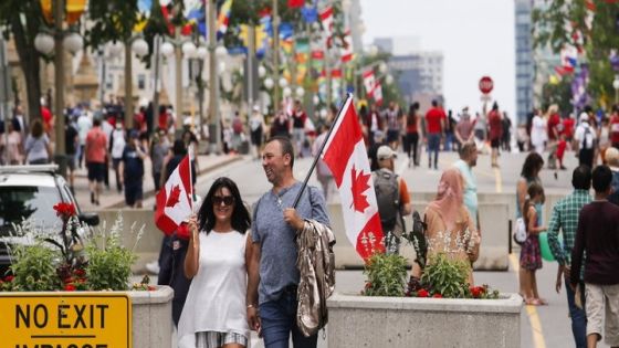 People carry national flags of Canada on Canada Day, in Ottawa, Ontario, Canada July 1, 2022. REUTERS/Patrick Doyle