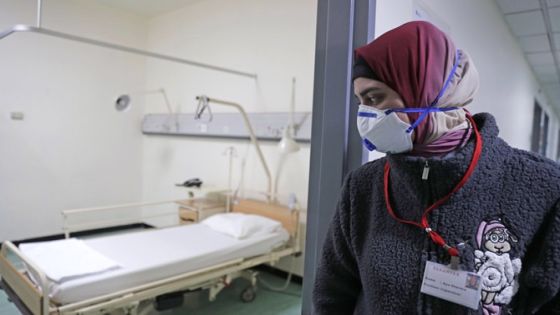 A Lebanese employee wearing a protective mask looks at a bed in a ward where the first case of coronavirus in the country is being treated, at the Rafik Hariri University Hospital in the southern outskirts of the capital Beirut, on February 22, 2020. Lebanon confirmed on February 21, the first case of the novel coronavirus, found in a 45-year-old Lebanese woman who had travelled from the holy city of Qom in Iran, while two other cases were being investigated. / AFP / ANWAR AMRO