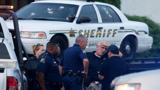 BATON ROUGE, LA - JULY 17: Police officers stand in front of an East Baton Rouge police car with bullet holes as it's towed away from the scene where three police officers were killed this morning on July 17, 2016 in Baton Rouge, Louisiana. The suspect, identified as Gavin Long of Kansas City, is dead after killing three police officers and injuring three more. Sean Gardner/Getty Images/AFP