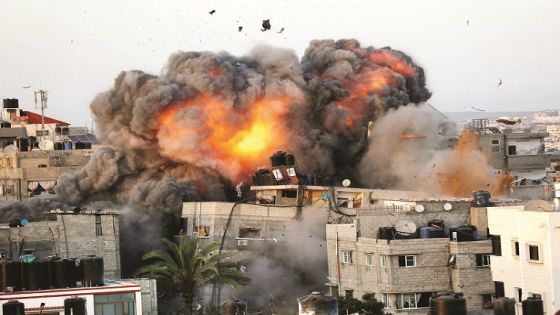 TOPSHOT - A ball of fire erupts from a building in Gaza City's Rimal residential district on May 16, 2021, during massive Israeli bombardment on the Hamas-controlled enclave. / AFP / Bashar TALEB