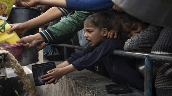 Palestinians line up for a free meal in Rafah, Gaza Strip, Thursday, Dec. 21, 2023. International aid agencies say Gaza is suffering from shortages of food, medicine and other basic supplies as a result of the two and a half month war between Israel and Hamas. (AP Photo/Fatima Shbair)