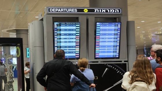 Passengers look at a departure board at Ben Gurion Airport near Tel Aviv, Israel, on October 7, 2023, as flights are canceled because of the Hamas surprise attacks. The conflict sparked major disruption at Tel Aviv airport, with American Airlines, Emirates, Lufthansa and Ryanair among carriers with cancelled flights. (Photo by GIL COHEN-MAGEN / AFP)